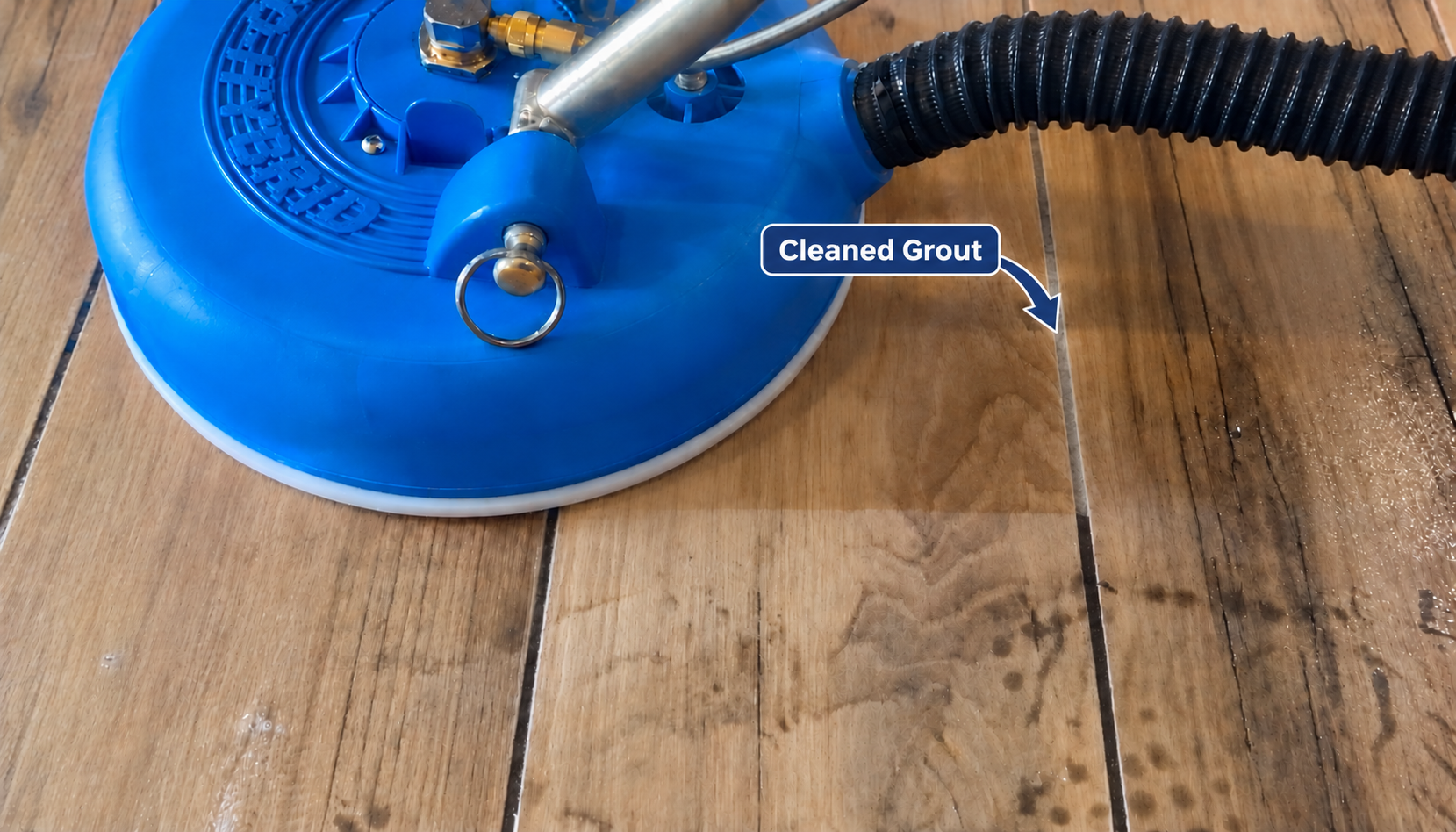 Actual tile and grout cleaning photo with an arrow indicating the cleaned grout line to the right of the blue wand